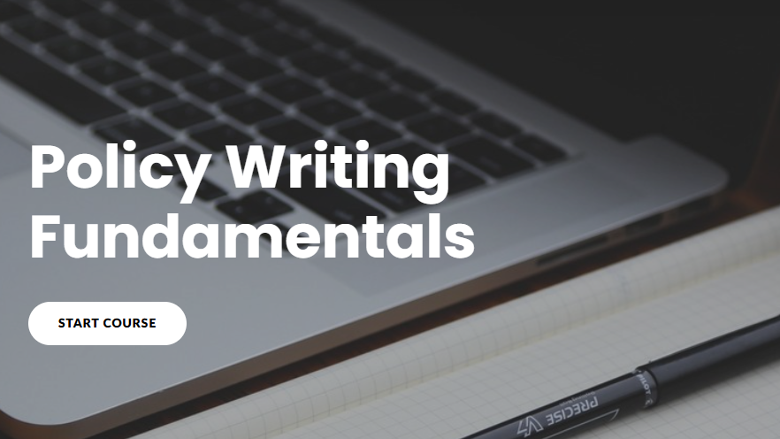 Laptop with 'Policy Writing Fundamentals' text and a pen on a desk