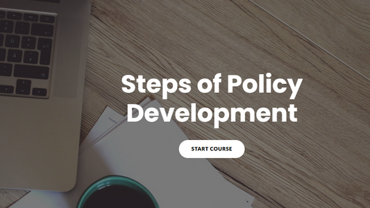 Laptop and mug on a wooden surface with 'Steps of Policy Development' text overlay.